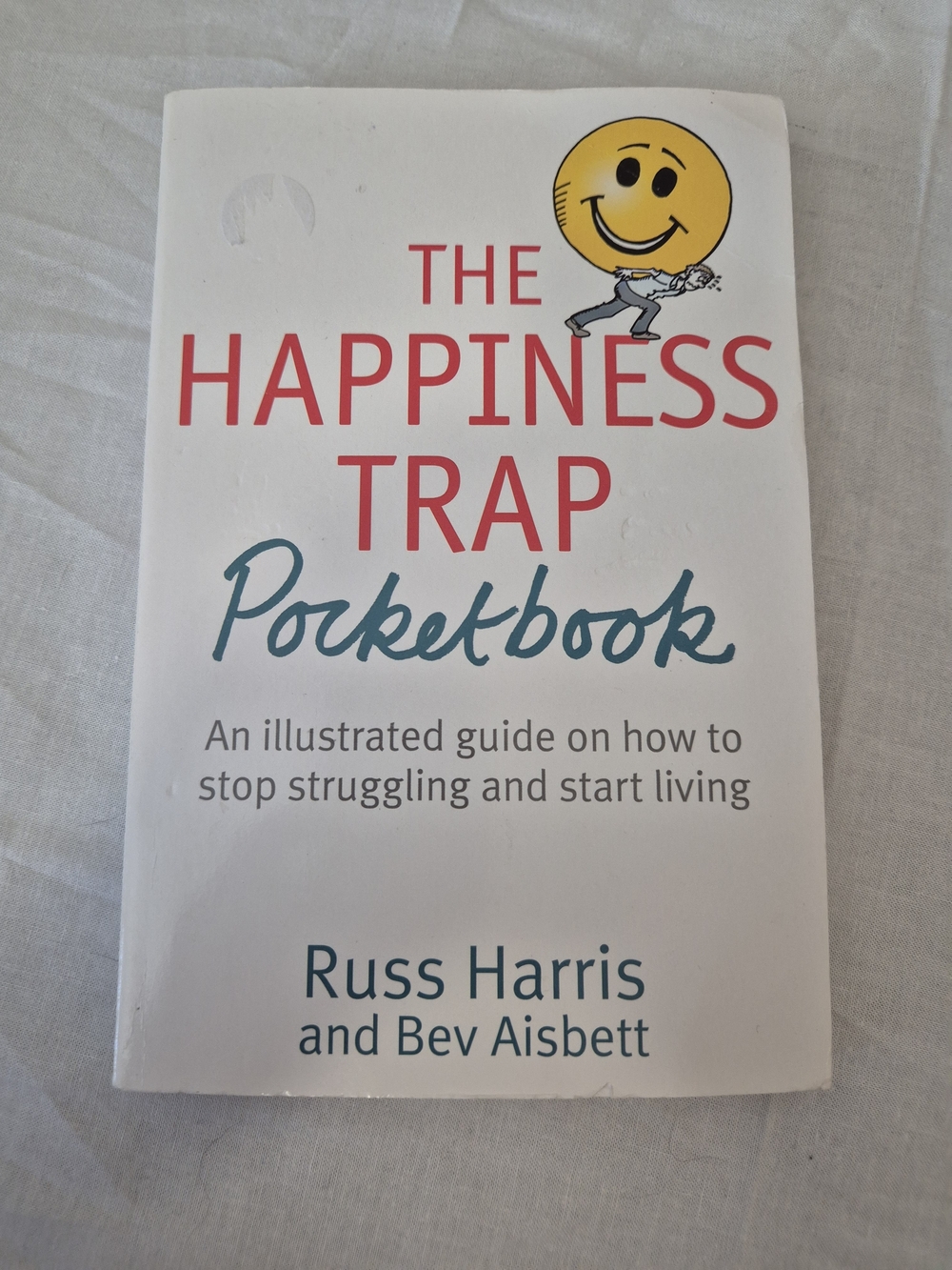 The Happiness Trap Pocketbook - White with Yellow Smiley